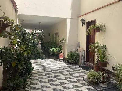 a courtyard with potted plants in a building at Historic Quinta, Heart of Miraflores, 2 Bedroom Apartment in Lima