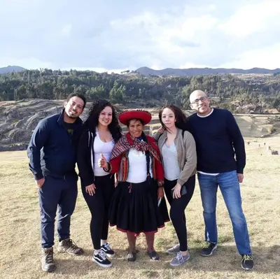 a group of people posing for a picture at Cabañas lago piuray in Chinchero