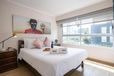 a bedroom with a large bed and a large window at Art&U Apartments by Vibrant in Lima