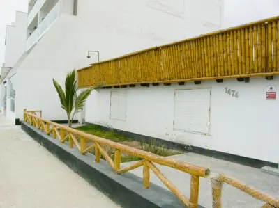 a wooden bench in front of a building at Apartment with Beach Exit 203 in Punta Negra