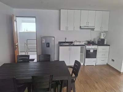a kitchen and dining room with a table and chairs at Apartment with Beach Exit 203 in Punta Negra