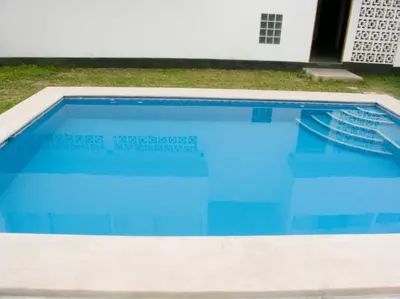 a swimming pool with blue water in a yard at Apartment with Beach Exit 204 in Punta Negra