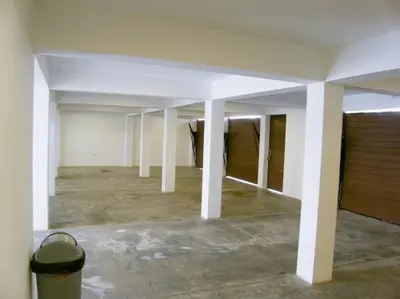 an empty room with white pillars in a building at Apartment with Beach Exit 204 in Punta Negra