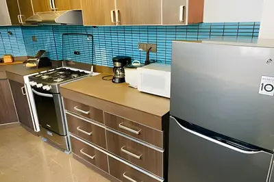 a kitchen with a stove and a refrigerator at Apto/ cama king2 en el centro Miraflores in Lima