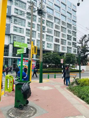 a trash can on a city street with a building at Apto/ cama king2 en el centro Miraflores in Lima