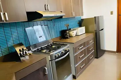 a kitchen with a stainless steel stove top oven at Apto/ cama king2 en el centro Miraflores in Lima