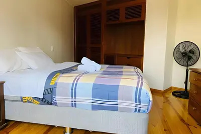 a bed in a bedroom with a clock on the wall at Habitación Acogedora con Baño Privado y Entrada Propia en Miraflores in Lima