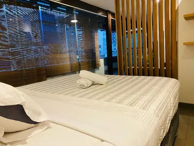 a bedroom with a bed with two towels on it at Tu Refugio en Miraflores – Céntrico y Tranquilo in Lima
