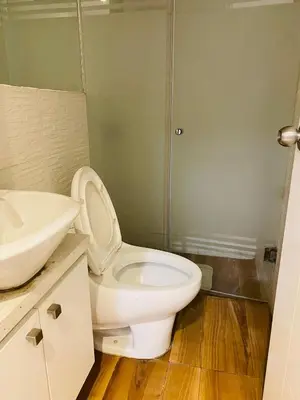 a bathroom with a white toilet and a sink at Tu Refugio en Miraflores – Céntrico y Tranquilo in Lima