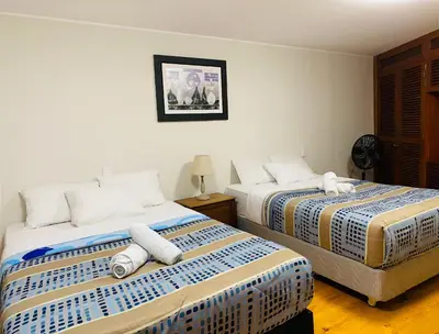two beds sitting next to each other in a room at Suite Independiente con Baño Privado – Miraflore in Lima
