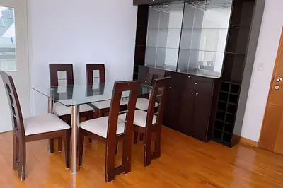 a dining room with a glass table and chairs at SM3 Habitación pequeña con baño privado/Miraflores in Lima