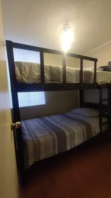 a bunk bed with a light on top of it at Dpto entero 2 dormitorios 2 baños máximo 5 personas in Lima