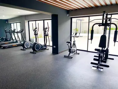 a gym with several treadmills and exercise bikes at Apartamento con vista a San Isidro in Lima