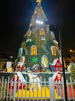a christmas tree is shown behind a white fence at Apartamento San Borja in Lima