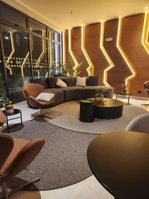 a living room with a couch and a table and chairs at Elegante Departamento de Estreno en Centro Financiero in Lima