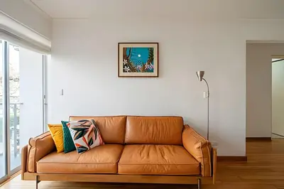 a brown leather couch in a living room at Central Bloom Miraflores in Lima