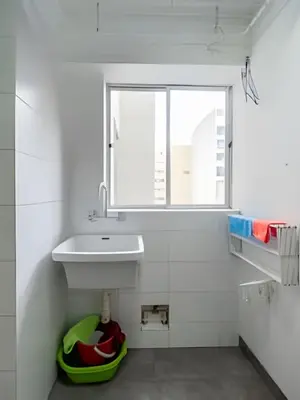 a white bathroom with a sink and a window at Central Bloom Miraflores in Lima