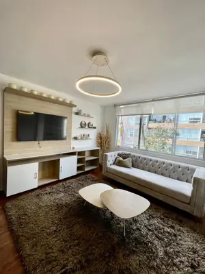 a living room with a couch and a tv at Apartment with 3 bedrooms near the sea in Miraflores in Lima