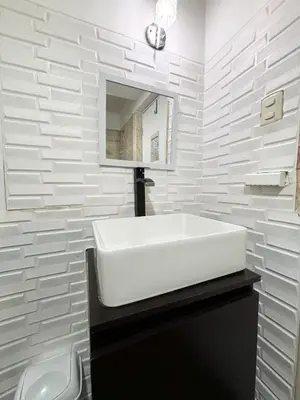 a white bathroom with a sink and a mirror at Apartment with 3 bedrooms near the sea in Miraflores in Lima