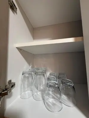a row of wine glasses sitting in a refrigerator at Apartment in Victoria in Lima