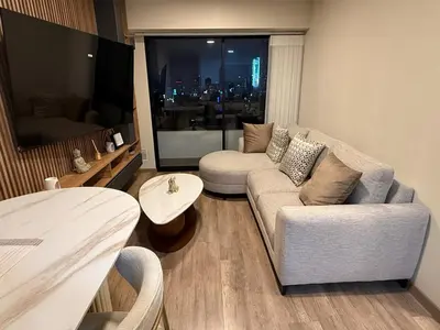 a living room with a couch and a table at Apartment in Victoria in Lima