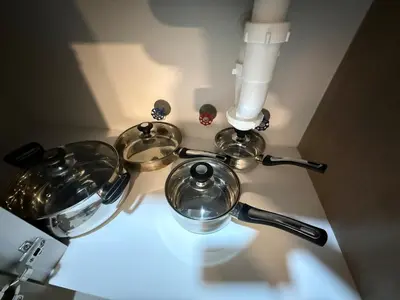 a stove with two pots and pans on it at Apartment in Victoria in Lima