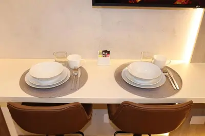 a table with plates and glasses on top of it at Ama Loft Miraflores in Lima