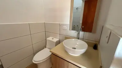 a bathroom with a white toilet and a sink at Casa Huerta Vista Bonita in Canta