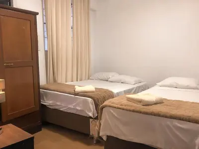 a room with two beds with towels on them at Mini departamento con cochera in Ayacucho
