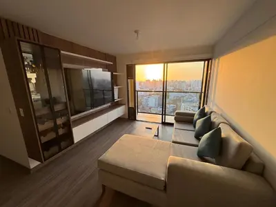 a living room with a couch and a large window at Cozy Room in Miraflores with rooftop pool in Lima