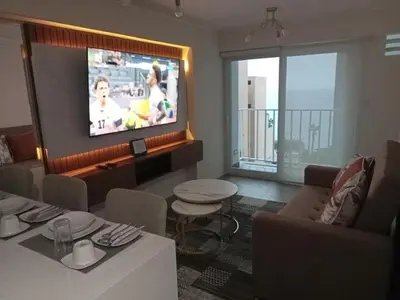 a living room with a flat screen tv on a wall at Edificio The sight Barranco vista al mar in Lima