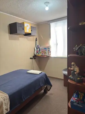 a bedroom with a bed and a window with toys at Three-bedroom apartment in San Miguel in Lima