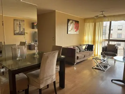 a living room with a dining table and a couch at Three-bedroom apartment in San Miguel in Lima