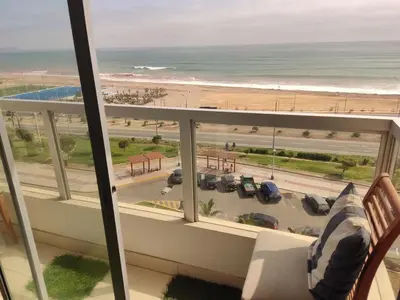 a balcony with a view of the beach and the ocean at Departamento Costa Verde San Miguel in Lima