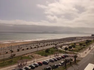 a parking lot with cars parked next to the beach at Departamento Costa Verde San Miguel in Lima