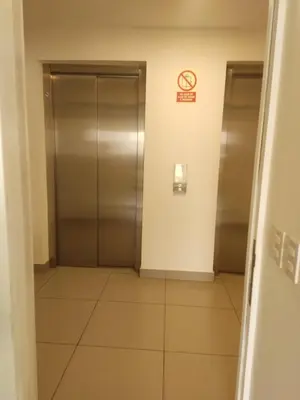 an elevator in a building with a no smoking sign at Departamento Costa Verde San Miguel in Lima