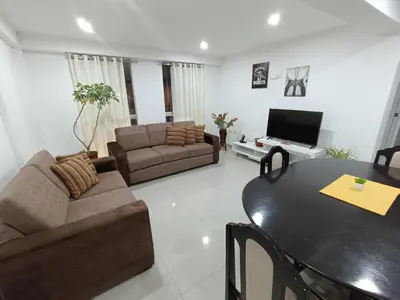 a living room with a table and a couch at Apartamento en Cusco III in Cusco