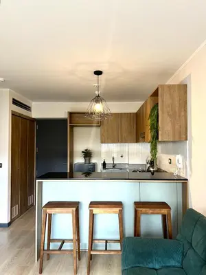 a kitchen with a counter and two stools at Beautiful Modern Apartment in Lima in Lima