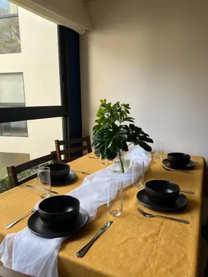 a table with plates and glasses on top at Beautiful Modern Apartment in Lima in Lima