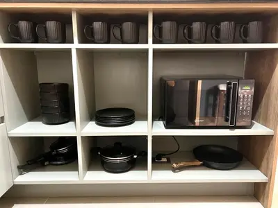 a kitchen cabinet with a microwave and some dishes at Beautiful Modern Apartment in Lima in Lima