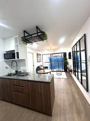 a kitchen and living room with a large counter top at moderno departamento con vista al mar en miraflores in Lima