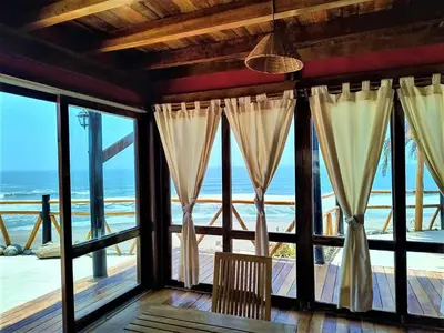 a room with large windows with a view of the ocean at Linda Casa de playa con vista al mar de Wakama in Jaguay