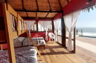 a bedroom with two beds and a balcony with the ocean at Linda Casa de playa con vista al mar de Wakama in Jaguay