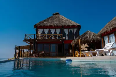 a resort with a swimming pool and a building at Linda Casa de playa con vista al mar de Wakama in Jaguay