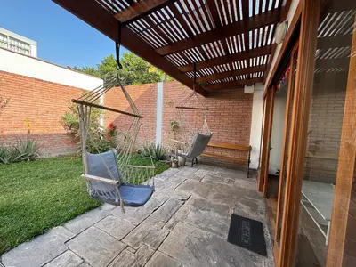 a patio with two chairs under a pergola at Casa amplia y acogedora, en Miraflores in Lima