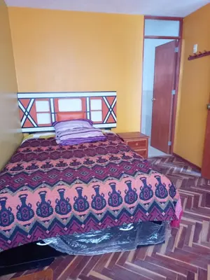 a bedroom with a bed with a colorful bedspread at Hospedaje Bienvenidos a mi Casa in Cerro de Pasco