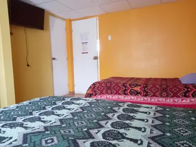 a hotel room with a bed with a colorful bedspread at Hospedaje Bienvenidos a mi Casa in Cerro de Pasco
