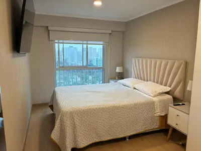 a bedroom with a bed and a large window at Magical View Parque de las Aguas, central apartment in Lima