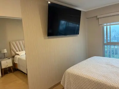 a bedroom with a bed and a television on the wall at Magical View Parque de las Aguas, central apartment in Lima