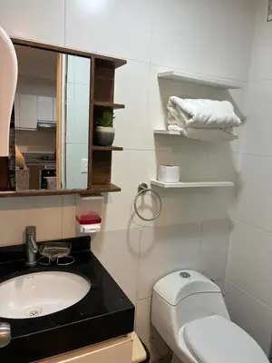a bathroom with a sink and a toilet and a mirror at Magical View Parque de las Aguas, central apartment in Lima